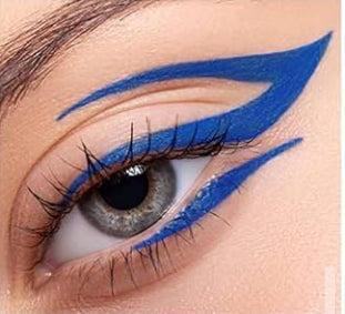 Close-up of an eye with bold, vibrant blue graphic eyeliner applied in a precise, layered wing design.