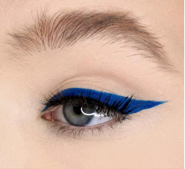 Close-up of a vibrant blue winged eyeliner look using Ashunta Sheriff vegan paint liner on a natural eyelid.