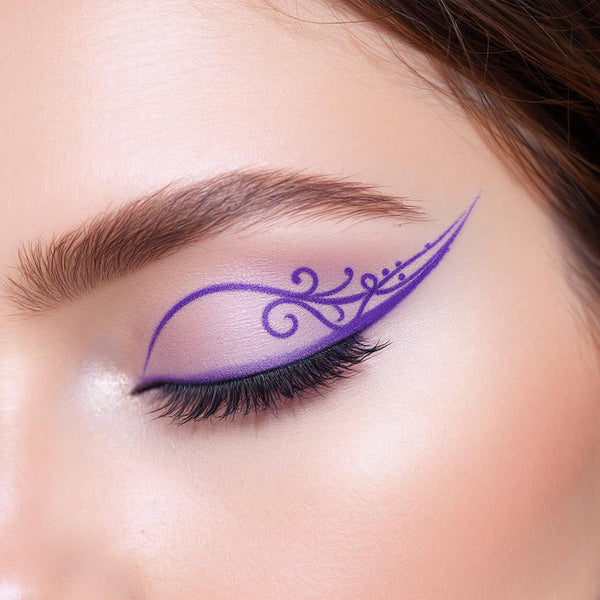 Close-up of an eye with intricate purple UV vegan paint liner in a decorative, winged filigree design.
